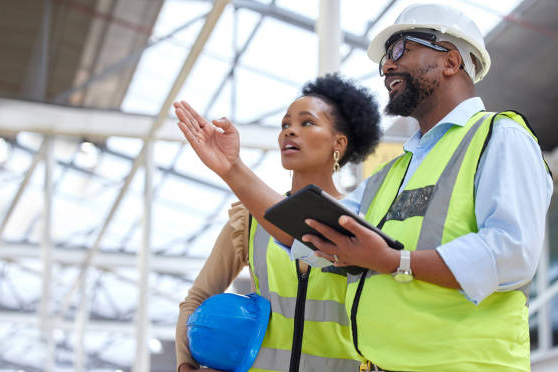 Construction job, strategy talk and teamwork from engineer planning staff at job site. Collaboration, architect team and communication together with tablet and industrial project with conversation